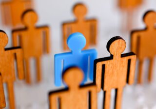 Blue Person highlighted in a group of monochromatic people